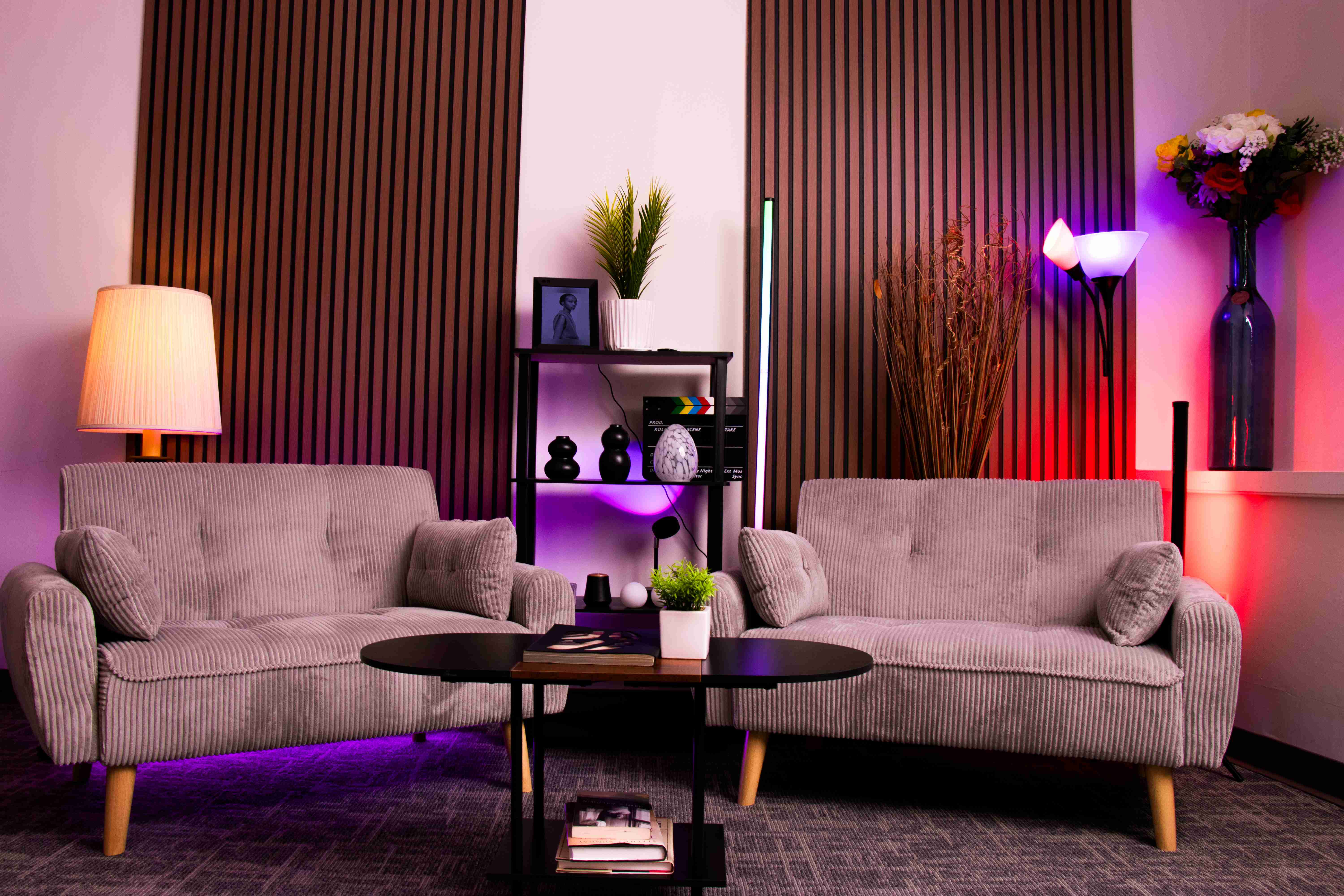 Empire Studio podcast lounge with corduroy sofas and cinematic accent lighting
