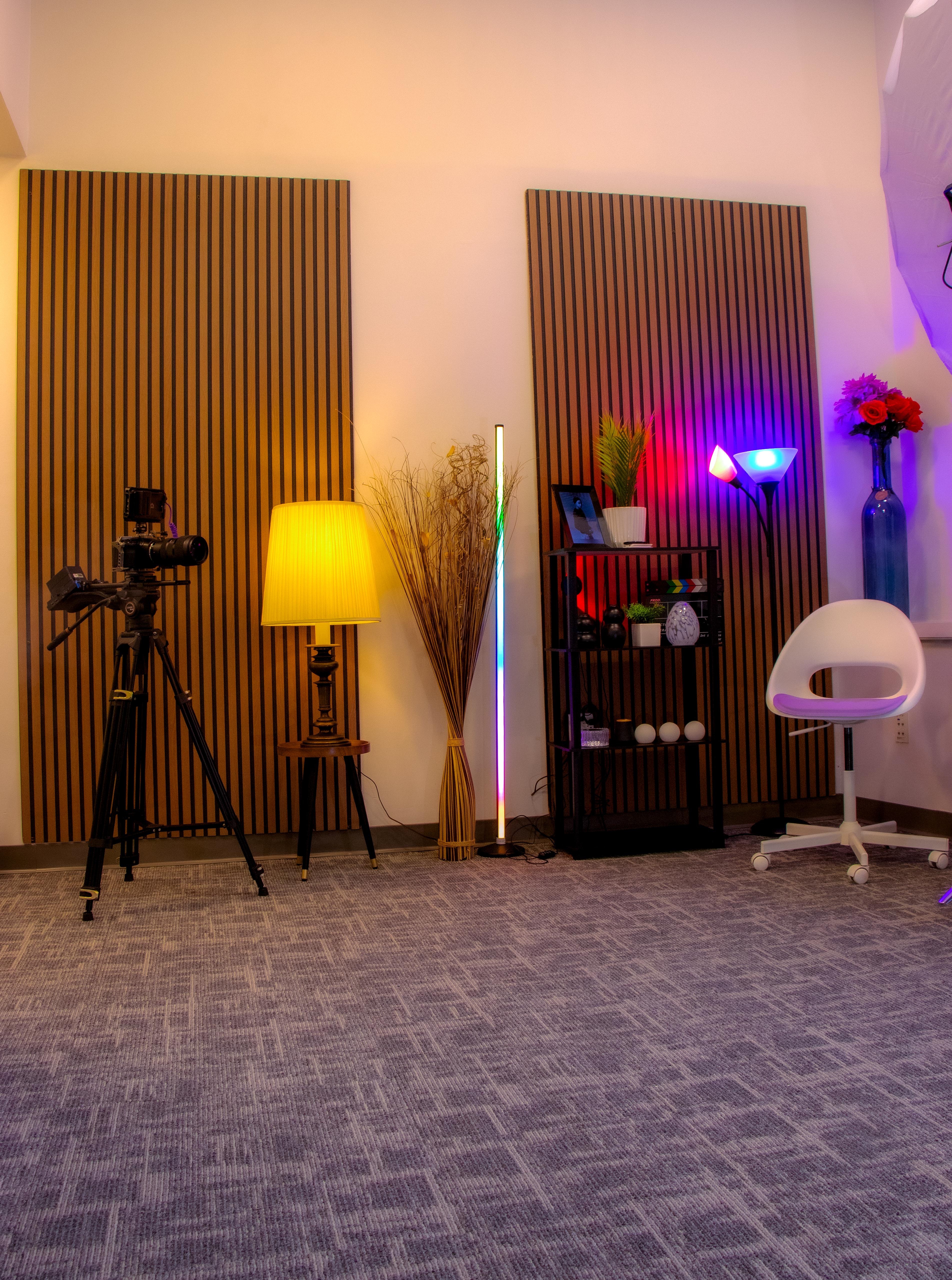 Versatile studio set with a cinema camera on a tripod, ambient lighting, and styled decor
