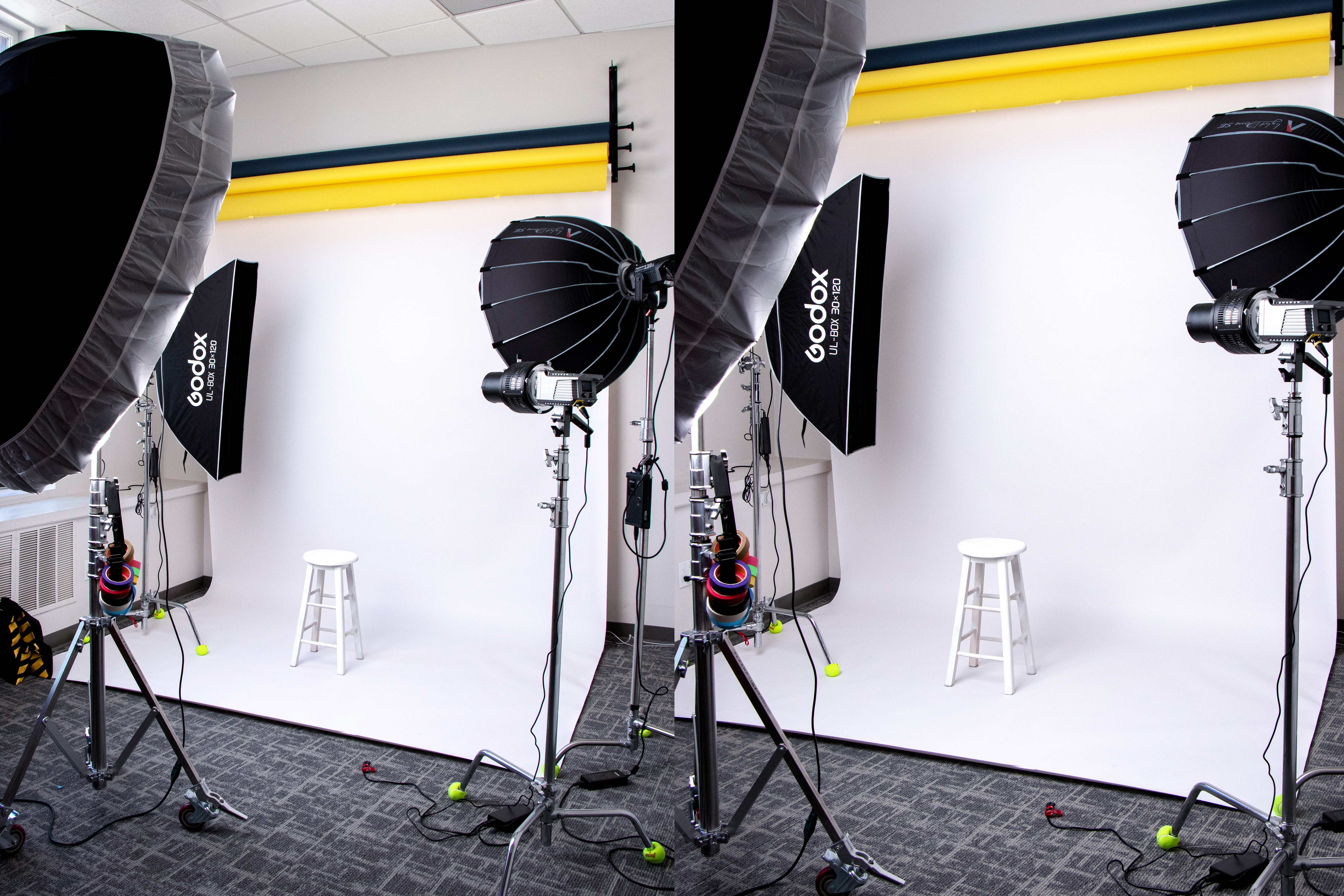 Photography studio with a white seamless backdrop, stool, and Godox softbox and parabolic lighting
