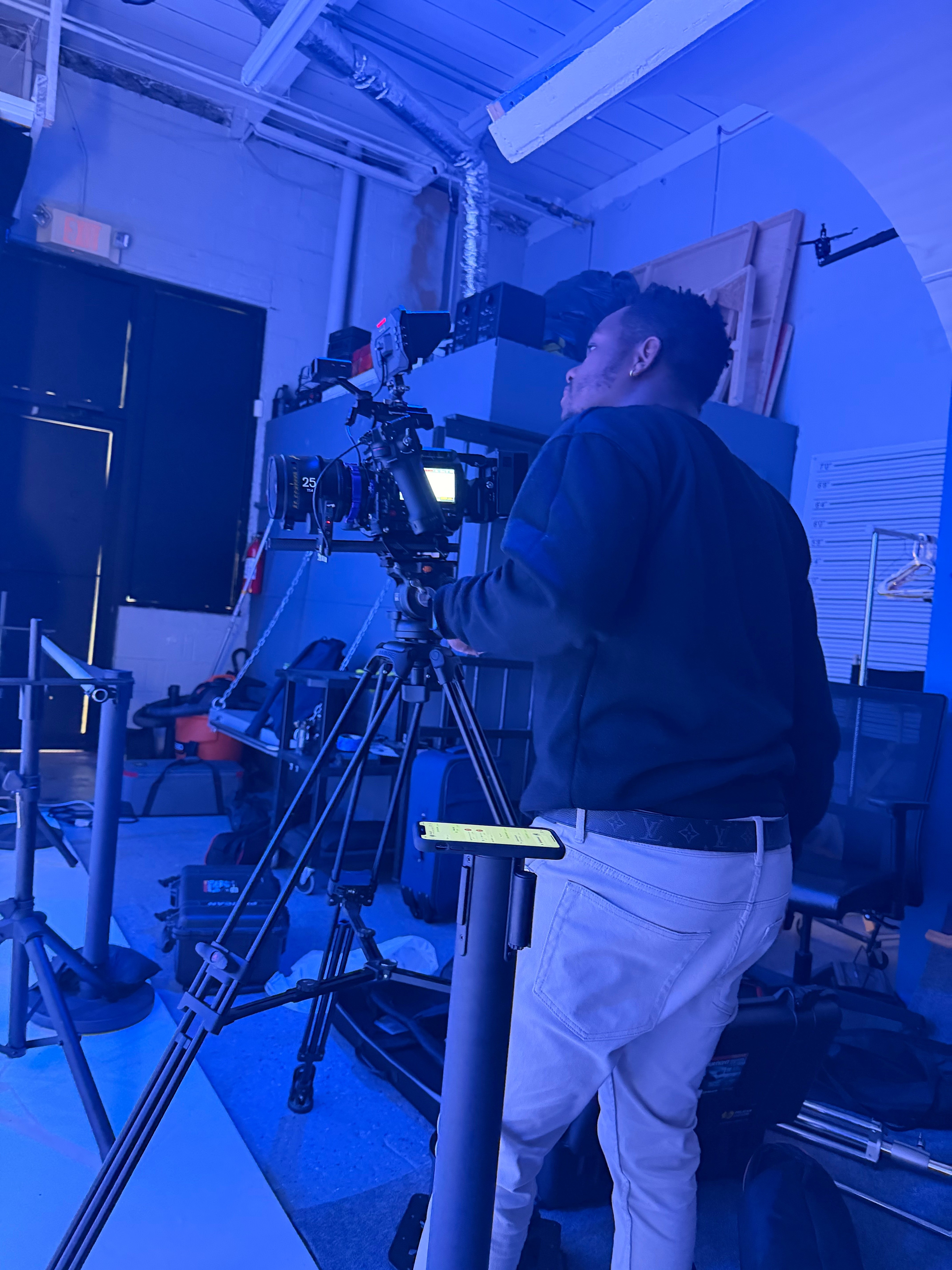 Operator framing a shot on a cinema camera in the Empire Studio production space